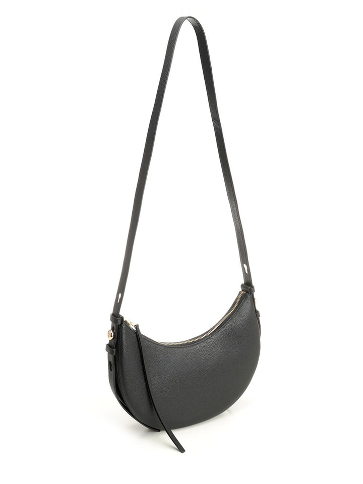 Tory Burch Romy Half Moon Bag Shoulder Bags - Nero | 4244caec3c40c0cf50c3e0c7d8b8bbb58be72cb3