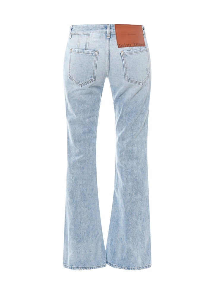Jeans in cotone con patch logo posteriore in pelle