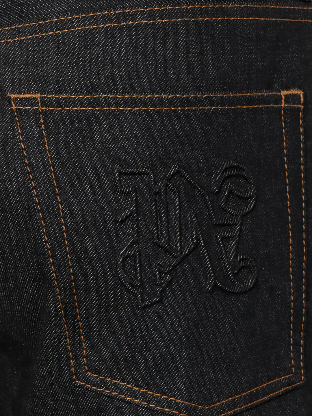 Jeans in cotone con monogramma in rilievo posteriore