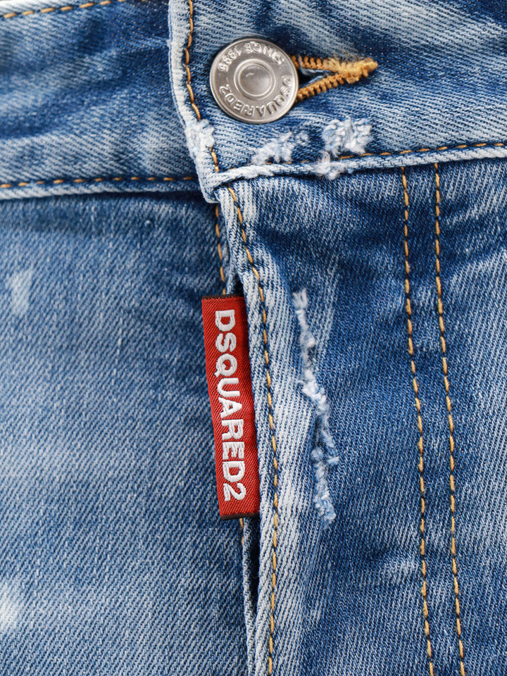 Jeans in cotone stretch con effetto strappato e macchie di vernice